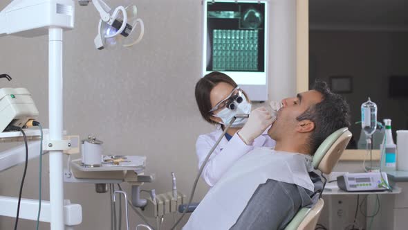 Dentist does dental treatment.