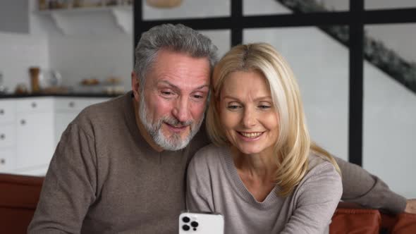 Middleaged Couple is Using Smartphone for Online Communication