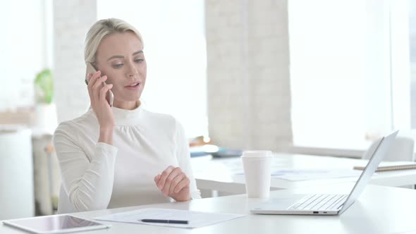 Cheerful Young Businesswoman Talking on Smartphone