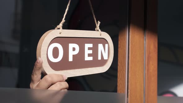 Small business opening up. Turning the sign from close to open. 4k 60fps