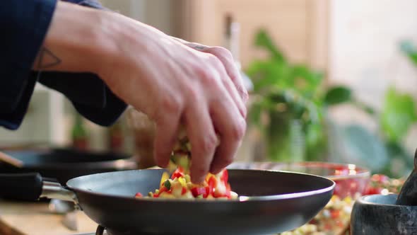 Hands of Male Cook Putting Chopped Vegetables on Frying Pan