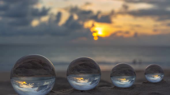 Time Lapse View Of The Beach In Sunset Inside Crystal Balls.