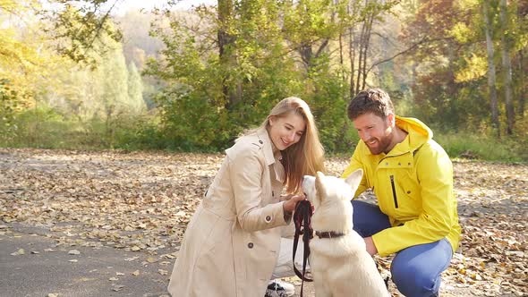 Close-up of a Happy Family with a Pet Dog, Autumn Day in the Park, Bright Colorful Trees Around