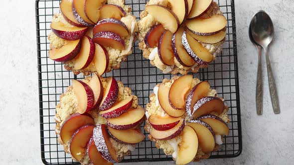 Homemade Crumble Tarts with Fresh Plum Slices Placed on Iron Baking Grill