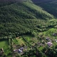 Aerial view over small village located on top of a high hill, at sunset - VideoHive Item for Sale