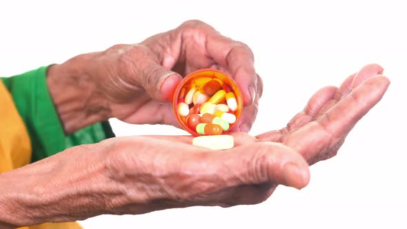 Close Up of Pills and Capsule on Senior Women's Hand
