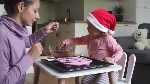 Caucasian Mother with Daughter Cooking Christmas Cookies Together. Holiday Traditional Home