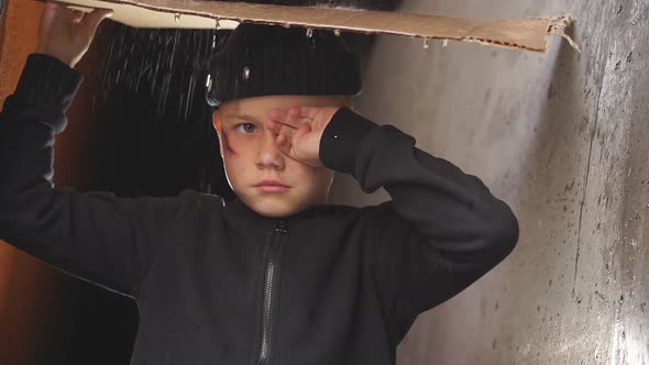 Poor Orphan Boy Shelters From Rain Under Cardboard Crying