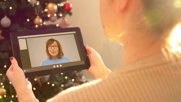 Woman with Tablet Pc Has Video Call on Christmas