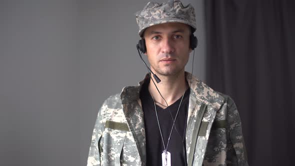 Portrait of a Man in Military Fatigues Face to Camera