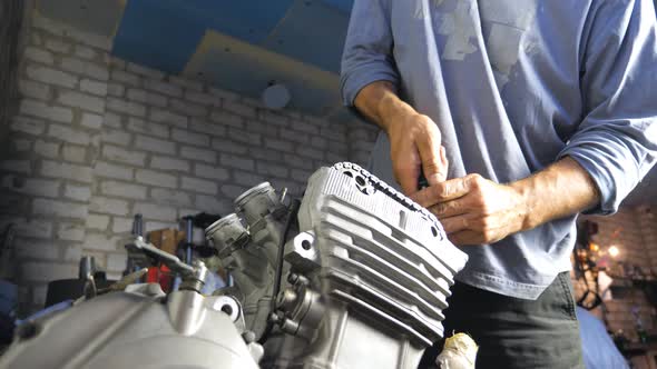 Unrecognizable Professional Mechanic Repairing Motor From Some Vehicle