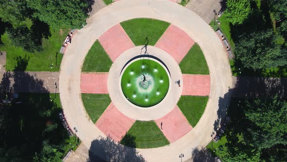 Copter descends to fountain in city square with monument to cosmonaut Gagarin