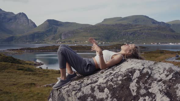 Woman lying on rock in nature