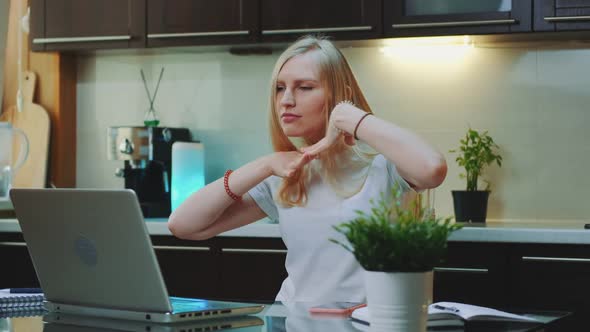 Blonde Woman Listening To the Music and Raising Her Arms in Front of Computer