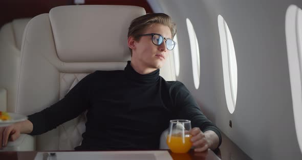 Stewardess Serving Meal for Male Passenger in First Class