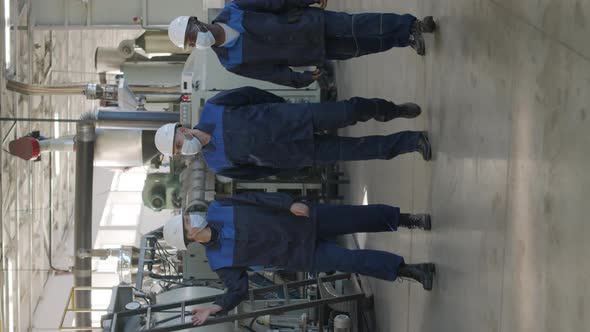  Vertical Shot of Plant Workers Walking and Talking