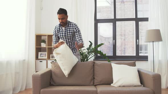 Indian Man Arranging Sofa Cushions at Home 104