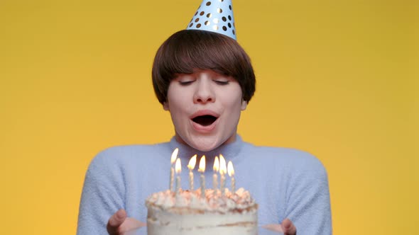 Pretty Woman Blowing Out Candles on Birthday Cake