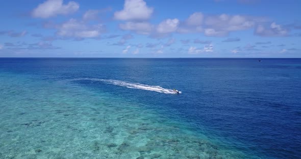 Natural drone island view of a paradise sunny white sand beach and blue ocean background in 4K
