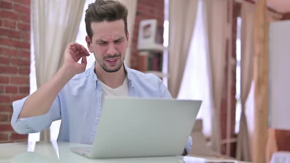 Tired Young Man Having Neck Pain at Home