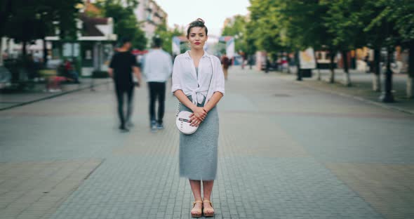 Time Lapse of Attractive Adult Woman Standing in City Center in Busy Street