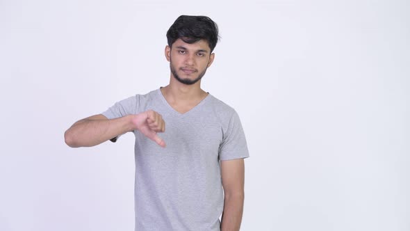 Young Sad Bearded Indian Man Giving Thumbs Down