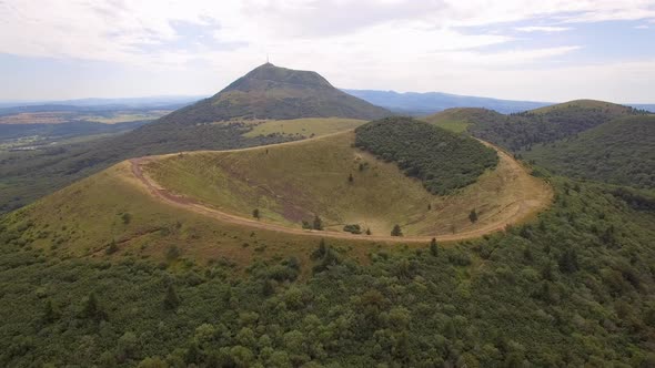 Aerial travel drone view of the Puy de Dome, lava dome volcano in France.