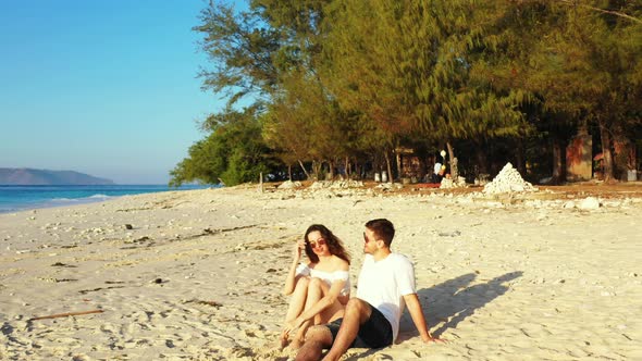 Beautiful people after marriage in love have fun on beach on white sand background 4K