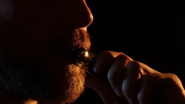 Guy Exhales Smoke Into a Dark Room, Black Background