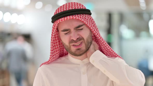 Portrait of Stressed Young Arab Businessman Having Neck Pain