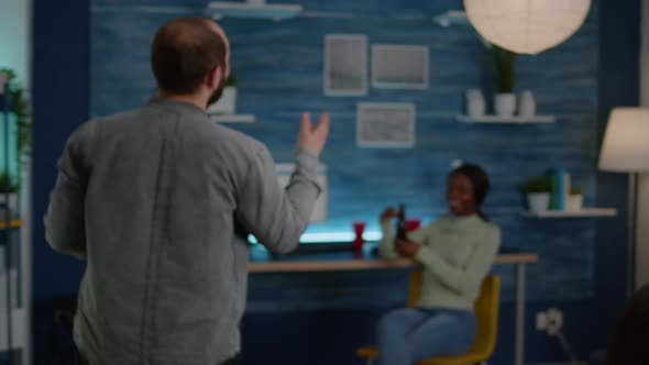 Happy Man Greeting His Mixed Race Friends While Talking with Black Woman