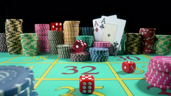 Set of Colorful Chips Playing Cards and Red Dice on a Gaming Table for Gambling in a Casino