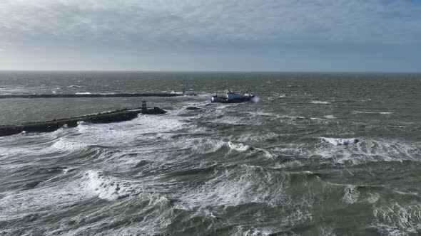 Aerial Drone Shot of Coast Guard Ship Leaving a Harbour in Rough Stormy Seas