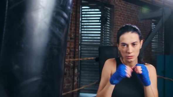 Beautiful Female Kickboxer with Wrapped Hand Boxing During Training Medium Closeup POV Shot