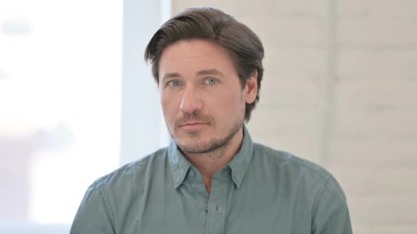 Portrait of Middle Aged Man showing No Sign by Shaking Head