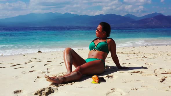 Women happy and smiling on marine seashore beach break by blue sea and white sand background of Gili