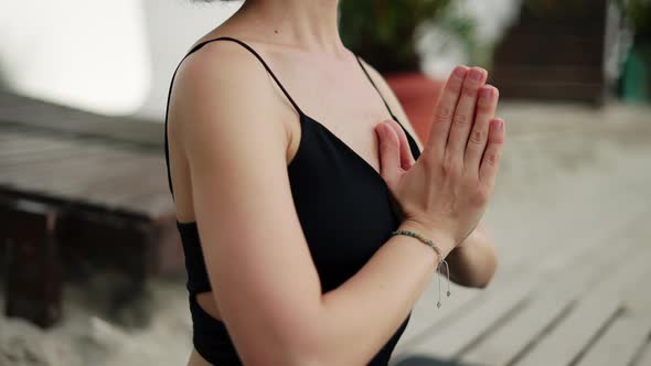 Cropped View of Female's Hands in Meditation on the Beach