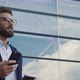 Handsome bearded Startup Businessman in Glasses using mobile Phone. - VideoHive Item for Sale
