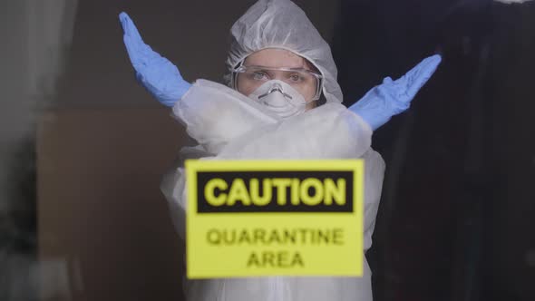Woman in Protective Suit in Quarantine Zone Signed Stop, Coronovirus and Isolation Concept