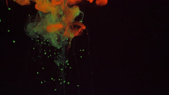 Mixing Particles of Glowing Colors of Green and Red Paint