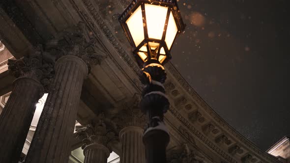 Streetlight Near Building with Columns in Winter Evening