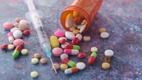 Syringe  Pills and Capsules on Table