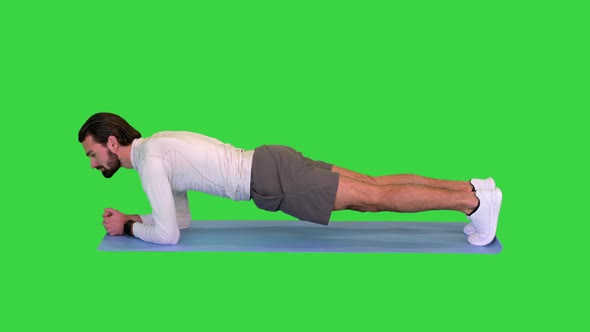 Fitness Man Doing Planking Exercise on a Green Screen Chroma Key