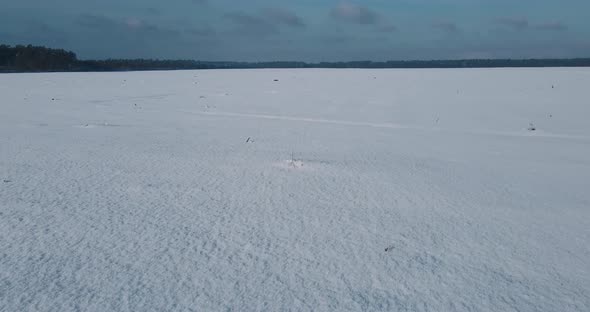 Aerial View Low Above The Ground Many Acres Of Snowy Field