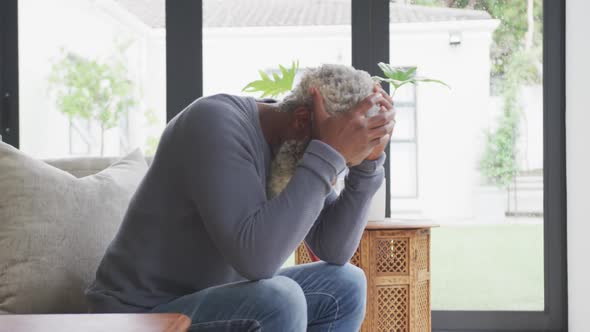 Video of sad african american senior man with walking stick