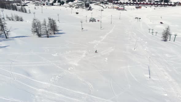 Aerial: one person skiing on snow in Sestriere ski resort, Turin Italy