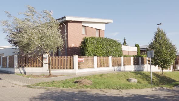 A Red Brick House on the Corner of a Street in an Urban Area