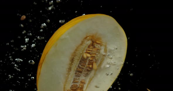 Half the Melon Falls Under Water with Air Bubbles. 