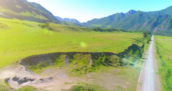 Aerial Rural Mountain Road and Meadow at Sunny Summer Morning