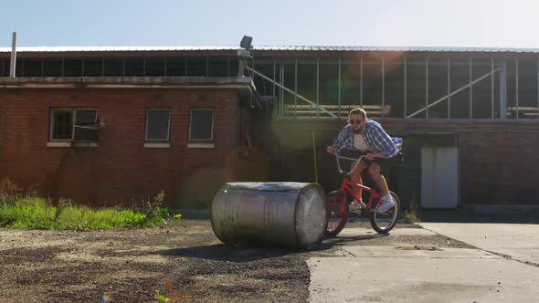 BMX rider doing trick in an empty yard